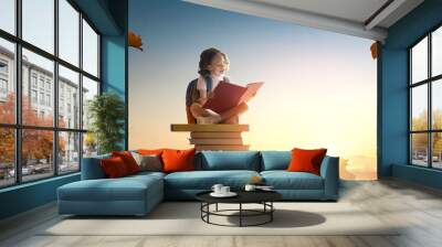 child on the tower of books Wall mural