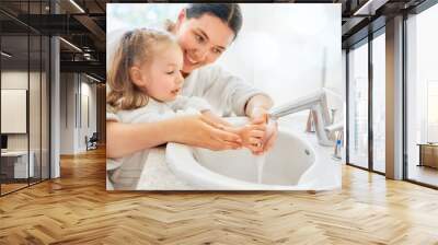 girl and her mother are washing hands Wall mural