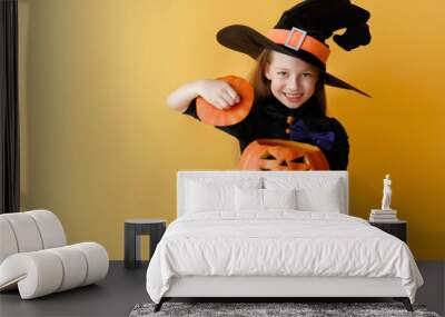 girl in witch costume with Halloween pumpkin Wall mural