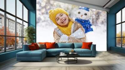 girl playing with a snowman Wall mural