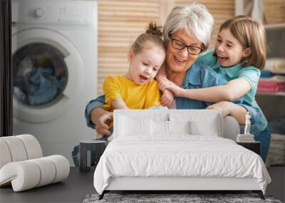 grandma and children are doing laundry Wall mural