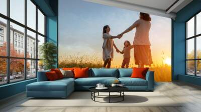 Happy family at sunset Wall mural