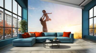 Happy family at sunset Wall mural