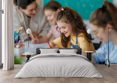 Happy kids and teacher at school Wall mural