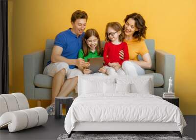 Happy loving family on bright color background. Wall mural