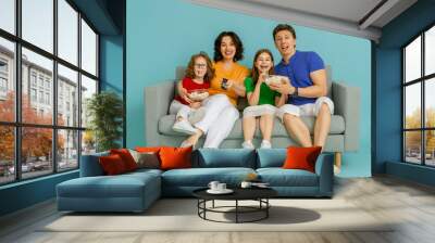 Happy loving family on bright color background. Wall mural