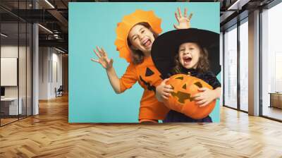 little witch and pumpkin on turquoise background Wall mural