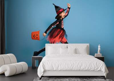 little witch on blue background Wall mural