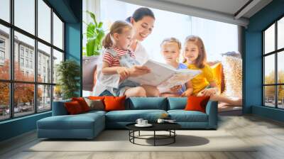 Mom and children reading a book Wall mural