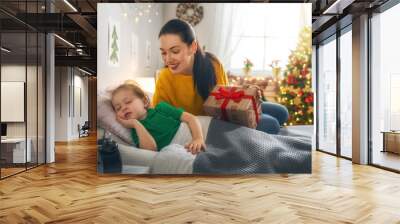 mom preparing Cristmas gift to daughter Wall mural