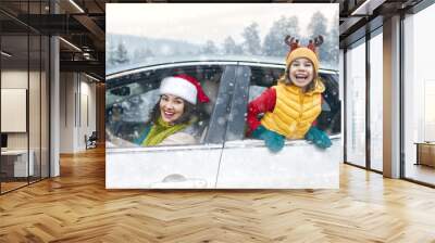 Mother, child and car on snowy winter nature Wall mural