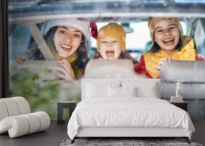 Mother, children and car on snowy winter nature Wall mural