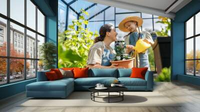 mother and daughter are gardening in the greenhouse Wall mural