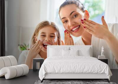 Mother and daughter caring for skin Wall mural