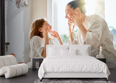 Mother and daughter caring for skin Wall mural