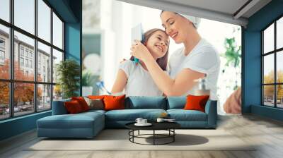 Mother and daughter combing hair Wall mural