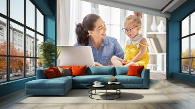 mother with toddler working Wall mural