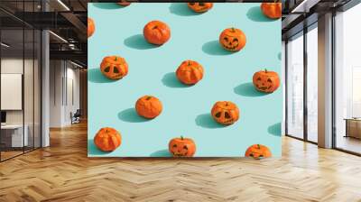 Pumpkins lanterns on turquoise background. Wall mural