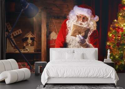 Santa Clause is preparing gifts Wall mural