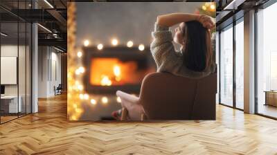 woman is relaxing near Christmas tree Wall mural