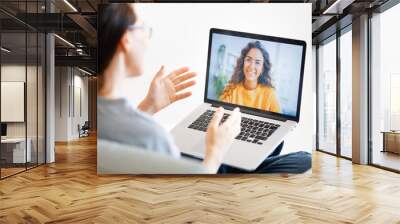 woman is using laptop for remote conversation Wall mural