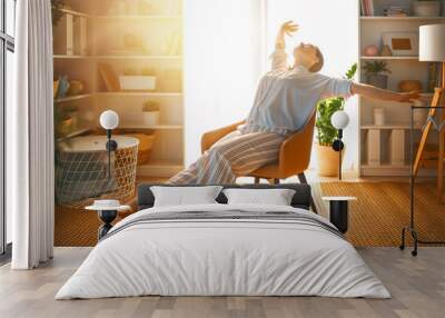 woman resting on armchair at home Wall mural