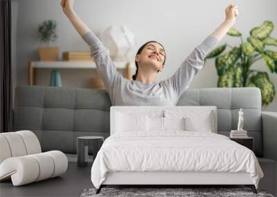 woman resting on sofa at home Wall mural