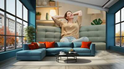 woman resting on sofa Wall mural