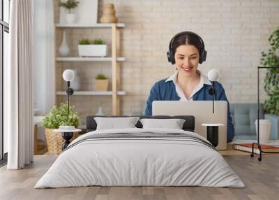 woman working on a laptop at home. Wall mural