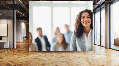 A female business trainer, coaching with a smile amidst a group of eager learners Wall mural