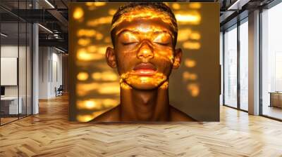 Golden light patterns on serene face with eyes closed Wall mural