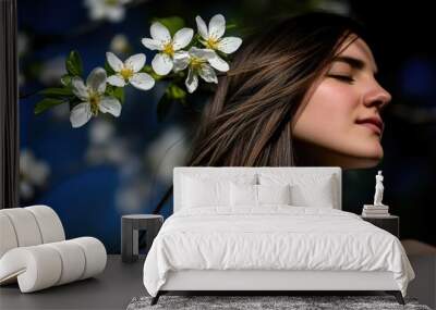 Serene woman relaxing in blooming orchard with white blossoms in springtime sunlight Wall mural