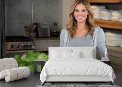 Woman preparing fresh lettuce in a modern kitchen setting Wall mural