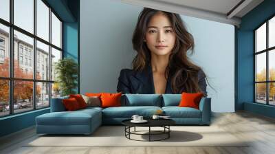 Beautiful asian businesswoman wearing a blue color suit smiling confidently Wall mural