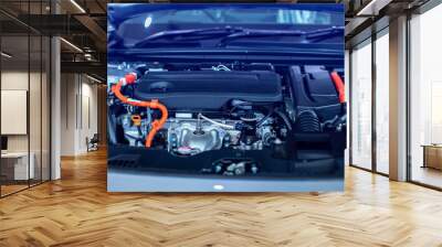 Selective focus to hybrid automotive industry part of modern new car engine room, Machine show all parts and open hood. Engine and electric motor room of new car. Wall mural