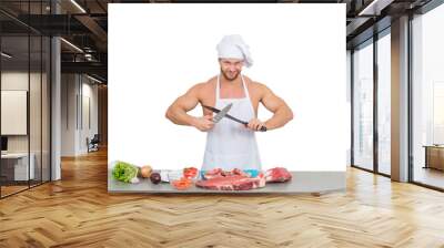 chef bodybuilder preparing large chunks of raw meat. Wall mural