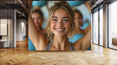 tan white  blue eyes woman is working out in the gym on pilate and ball with many other  women in gym class Wall mural