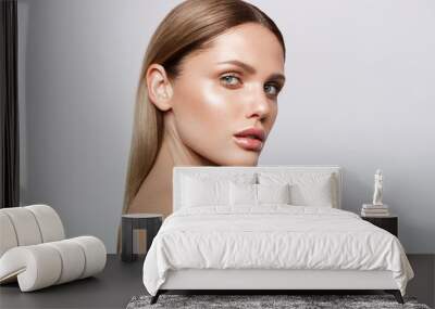 Beauty portrait of model with natural make-up. Fashion shiny highlighter on skin, sexy gloss lips make-up Wall mural