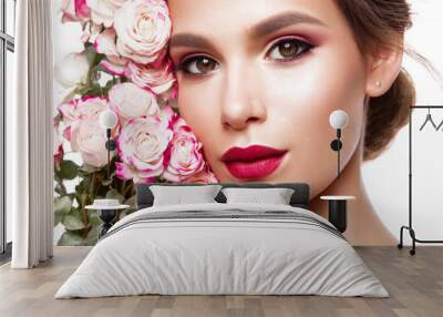 Portrait of young beautiful woman with stylish make-up and colorful roses around her face Wall mural