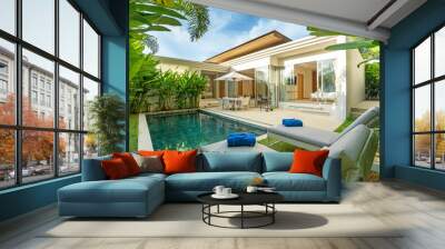 Interior and exterior design of luxury pool villa, house, home feature swimming pool, sunbed, blue beach towels and garden landscape Wall mural