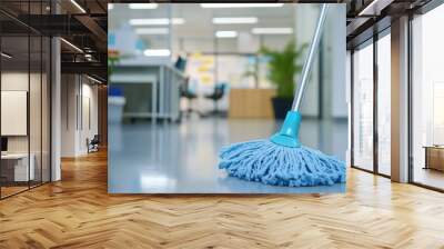 A blue mop with a blue handle is on a floor Wall mural