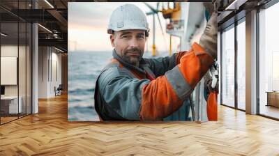 Offshore Wind Energy Engineer Dedicated professional wearing protective gear and helmet  standing amidst large wind turbines over the ocean symbolizing renewable energy and sustainable technology Wall mural