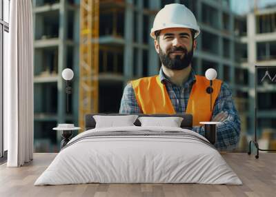 Portrait of a bearded male construction worker on the background of a building under construction. Wall mural