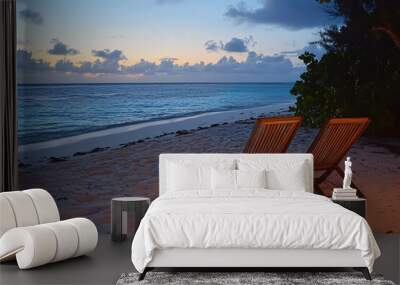 Two chairs on a tropical beach at sunset. Summer holiday concept. Wall mural