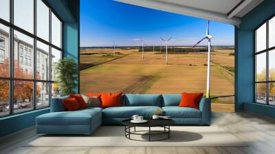 A line of wind turbines in Europe. Landscape with wind generators. The issue of energy saving in the modern world Wall mural