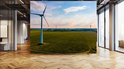 Wind turbines set up in green field, summer landscape. Energy concept Wall mural