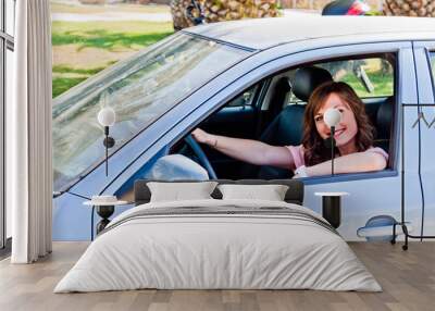 young and beautiful woman driving a car Wall mural