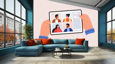 Video conference. Online meeting work form home. Hands hold mobile tablet. On-screen of the gadget, men, and women are chatting. Conversations and learning through social networks. Vector illustration Wall mural