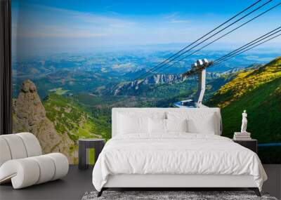 cable car on the ropes, going to Mount Kasprowy Wierch, Poland. Beautiful view of the valley Wall mural