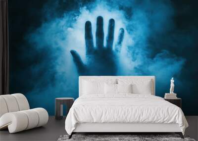 Hand silhouette in blue mist with glowing light Wall mural